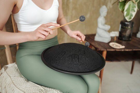 Woman Playing Handpan Drum Indoors