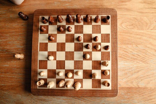 Top view of chessboard with pieces arranged in mid-game position.