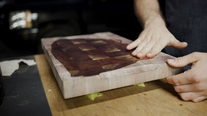 Application of oil finish on cutting board with rich wood