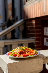 A plate of spaghetti pasta photographed in the warm sunlight