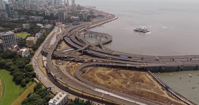 Morning view of the Mumbai Coastal Road in Maharashtra, India, famously known as the 'City of Dreams.' The scene captures a multileveled interchange roadway. A complex road network and urban design.