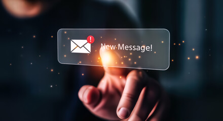 Finger touching a smartphone screen displaying a notification bubble with an envelope icon and the text new message, signifying communication, alerts, and digital interaction