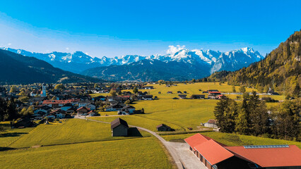 Alpine houses and green summer meadows