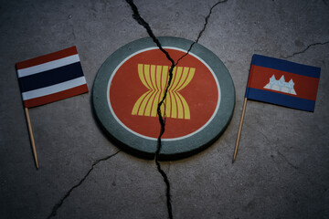 Broken regional cooperation emblem between two Southeast Asian countries, cracked symbol on concrete conveying tension and uncertainty