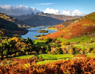 A vibrant valley scene, with a lake and mountains under a blue sky, shows autumn colors