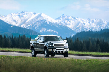 Fototapeta premium Black pickup truck driving on open highway