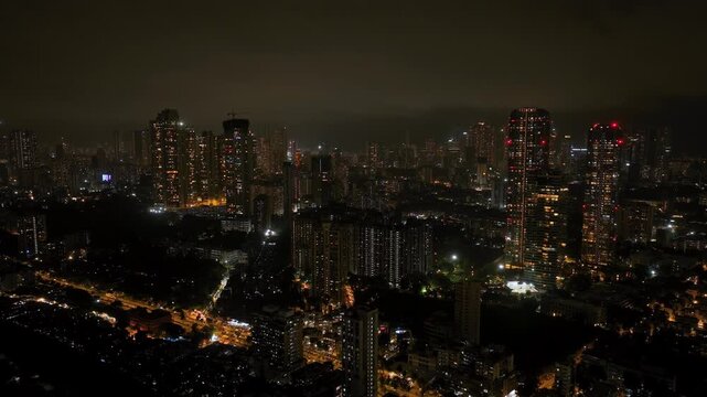 4K night view of a busy flyover bridge, highway in Mumbai, Skyscraper buildings in Mumbai at night, developing India concept