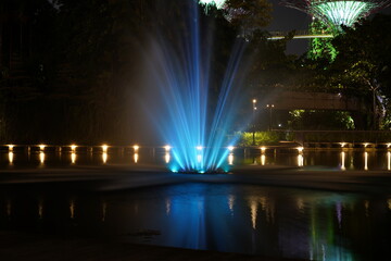 nighttime Supertree Grove Gardens by the Bay blue fountain glowing lights