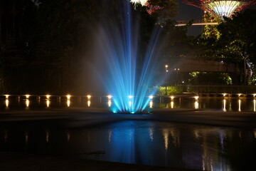 nighttime Supertree Grove Gardens by the Bay blue fountain glowing lights