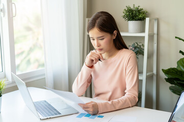 Deduction planning, debt asian young woman  hand using calculator to calculating money balance from...