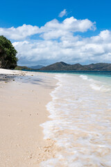 Tropical beach, white sand, calm turquoise ocean waves