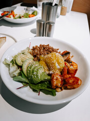 Fresh seafood salad with vegetables and grains served at a modern restaurant