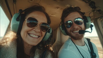 Happy woman and flight instructor posing for a photo in a helicopter