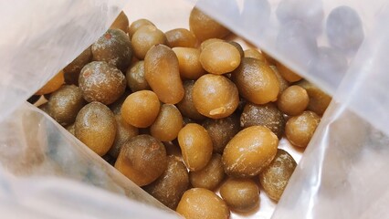 Dried tangerine peel, dried mandarin oranges or citrus, preserved fruit in plastic bag, Chen pi in Chinese, close up, macro