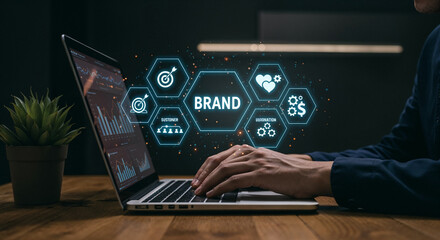 Person typing on laptop with brand strategy icons floating above branding marketing