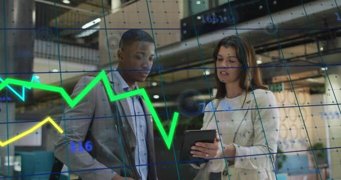 Female raising tablet and starting animated financial graph while male watching peaks and dips