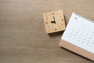 close up of calendar on the wooden table background, planning for business meeting or travel planning concept