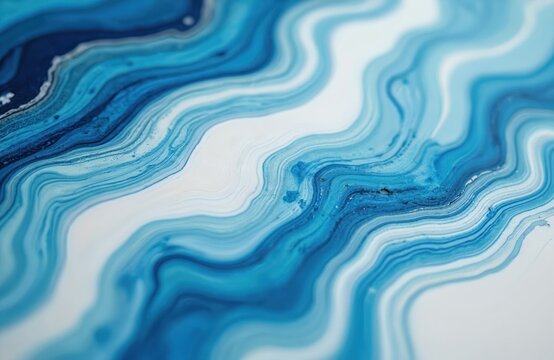 Close up of blue and white epoxy resin art. Swirling abstract patterns create a fluid marble texture. Detailed surface offers vibrant color flow and liquid effect.