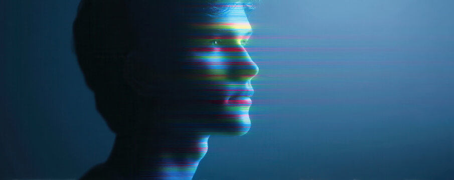 Profile of young man with digital glitch effect blue background futuristic technology concept creative portrait modern art thoughtful expression illuminated face cyberpunk style