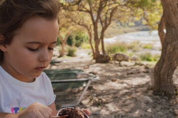 Simple summer joy: child enjoying a scoop of ice cream on a sunny day