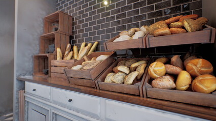 Warm tones fill the bakery as freshly baked bread sits in rustic wooden baskets. The inviting aroma of pastries creates a comforting atmosphere, perfect for morning visitors.