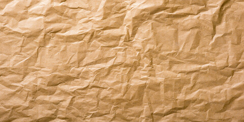 This image features a close-up texture of crumpled brown kraft paper with subtle horizontal lines. The paper appears worn and naturally wrinkled, giving it a rustic, organic, and handcrafted look. Its