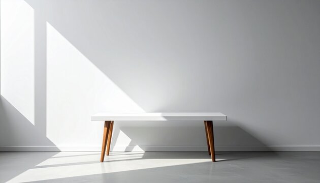 Minimalist interior with wooden bench and white cushion, sharp sunlight casting angular shadows on white wall and floor.