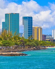 Fototapeta premium Modern high rise buildings overlooking a tropical ocean shoreline