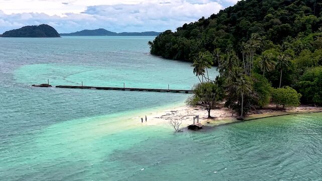 Pristine Phrao Nok Island in Koh Chang Thailand showcases turquoise waters and lush greenery.