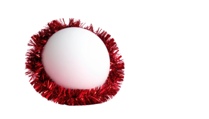 White orb nestled within a vibrant red tinsel wreath against a stark black background