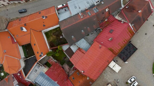 Aerial drone top-down shot showing the vibrant Renaissance rooftops of the historic UNESCO World Heritage town of Telč, Vysocina, Czech Republic.