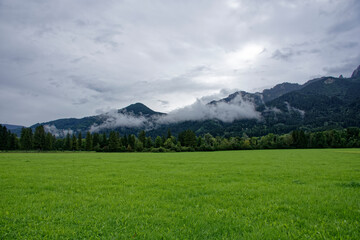 Fototapeta premium A cloudy autumn day near a castle at the foot of the Alps.