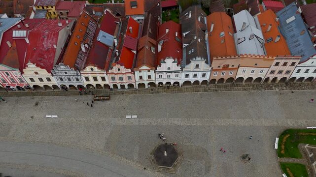 Drone shot showcasing the ornate gables and colorful Renaissance facades of the UNESCO World Heritage Site of Telč's main square, Vysocina region, Czechia.