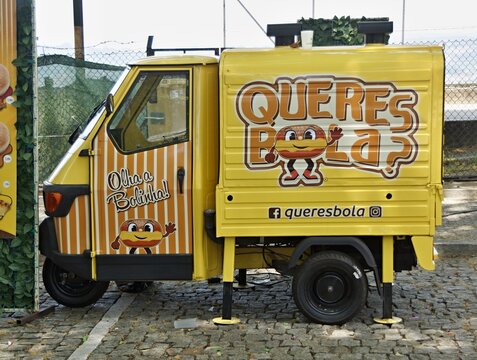 Yellow Piaggio Ape food truck selling donuts