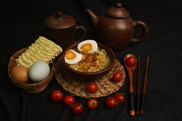 a bowl of boiled noodles with salted eggs