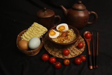 a bowl of boiled noodles with salted eggs
