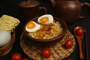 a bowl of boiled noodles with slice egg 