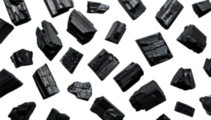 Rough-hewn, jagged black crystals scattered against a stark black background, casting shadows