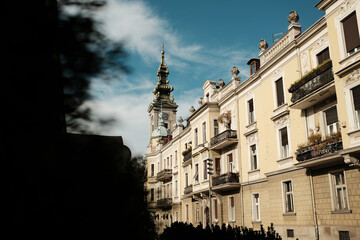 Historic architecture and church tower under blue autumn sky in Belgrade. Warm light and classic European charm