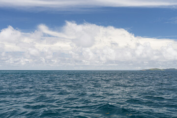 Ocean waves with turquoise water and white clouds