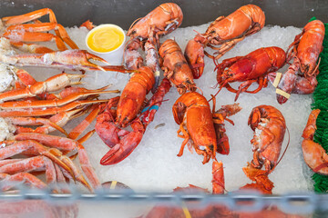 Cooked lobsters and crab legs on ice