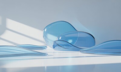 Transparent, blue, amorphous glass shapes on white surface, soft shadows