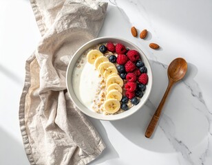 Healthy Oatmeal Breakfast Bowl with Fresh Berries, Banana Slices, and Almonds