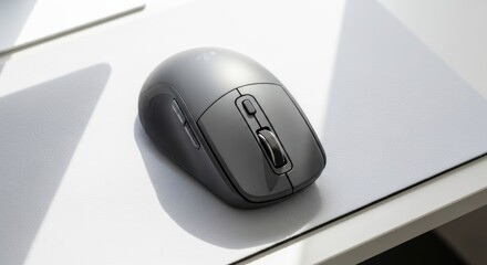 Gray computer mouse resting on a light colored textured surface.