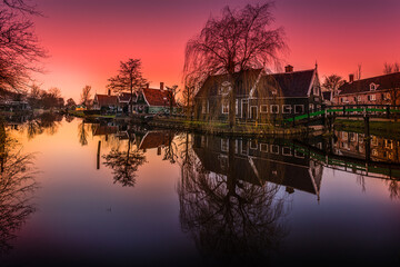 Fototapeta premium De Zaanse Schans is a neighborhood located in the city of Zandam. Historical windmills and old houses were relocated here to create the vintage look. And the famous Dutch canals near Amsterdam