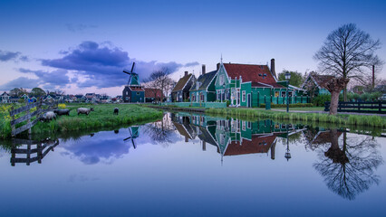 Fototapeta premium De Zaanse Schans is a neighborhood located in the city of Zandam. Historical windmills and old houses were relocated here to create the vintage look. And the famous Dutch canals near Amsterdam