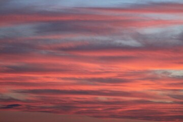 Fototapeta premium Fiery Horizon A Sky Ablaze with Sunset Hues. Pink and Blue Clouds