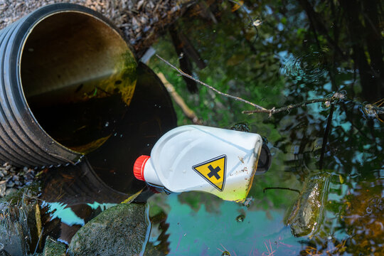 Radioactive pollution of the environment.A plastic bottle is lying in a ditch with sewage.Chemical production waste.