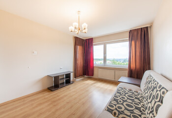 Minimalism Bedroom Interior. Windows and Red Curtains. Sunlight. Hardwood Floor.
