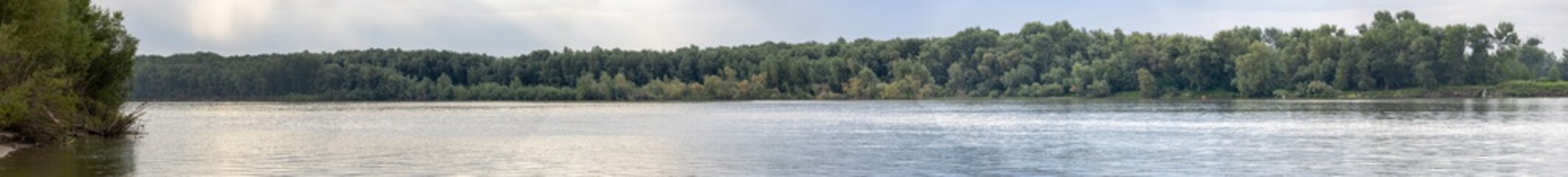 A panoramic view of a river with a forest on the banks of the Irtysh River in Kazakhstan
